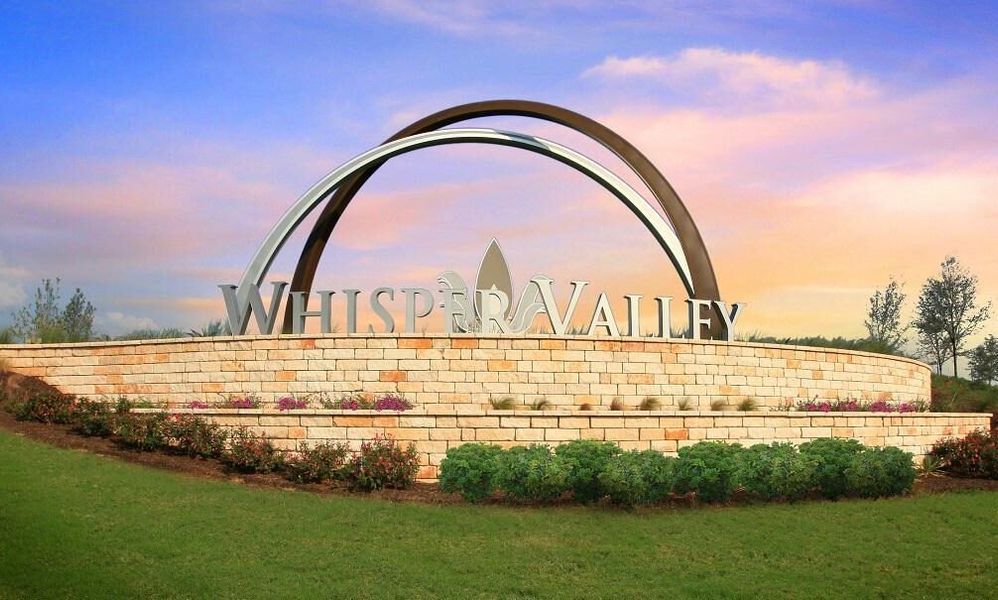 Entrance to the Whisper Valley Community community in Manor, TX, featuring signage and landscaping (Image 2).