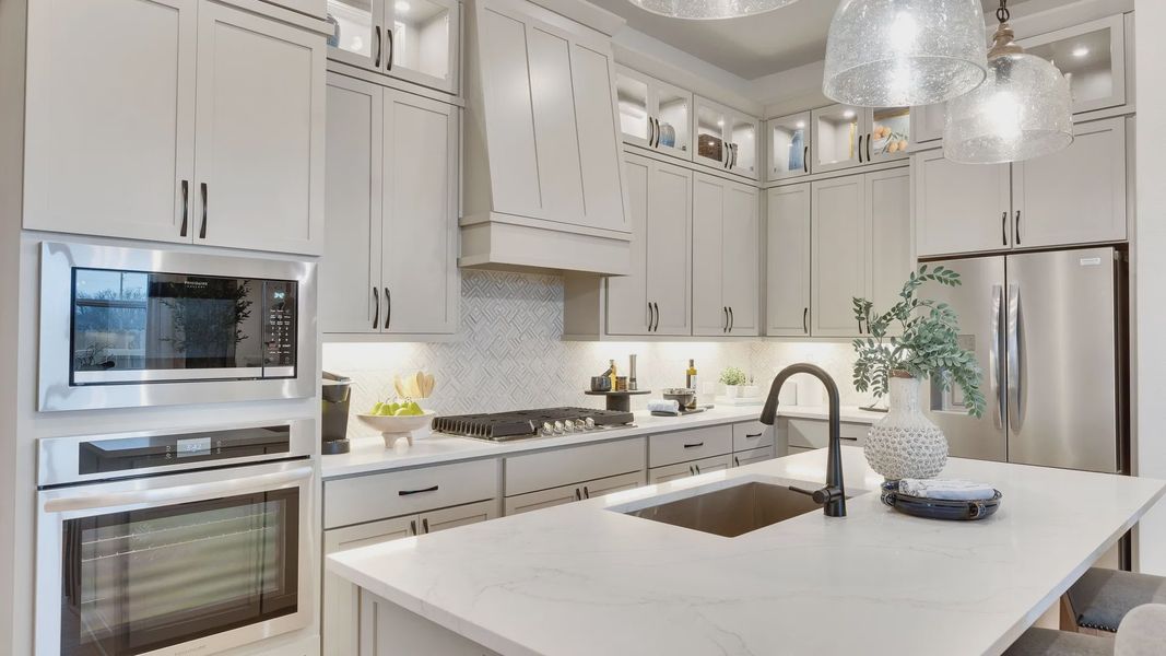 Luxurious Spring Creek kitchen featuring marble countertops and chic stainless appliances.