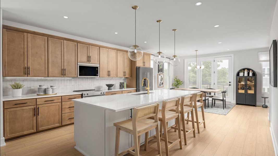 Gourmet kitchen boasts a large center island and stainless steel appliances