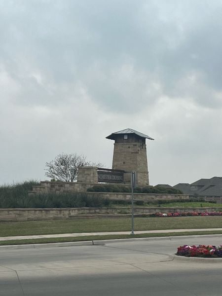 A charming stone entrance tower greets visitors to Winchester Crossing by D.R. Horton in Princeton, TX.