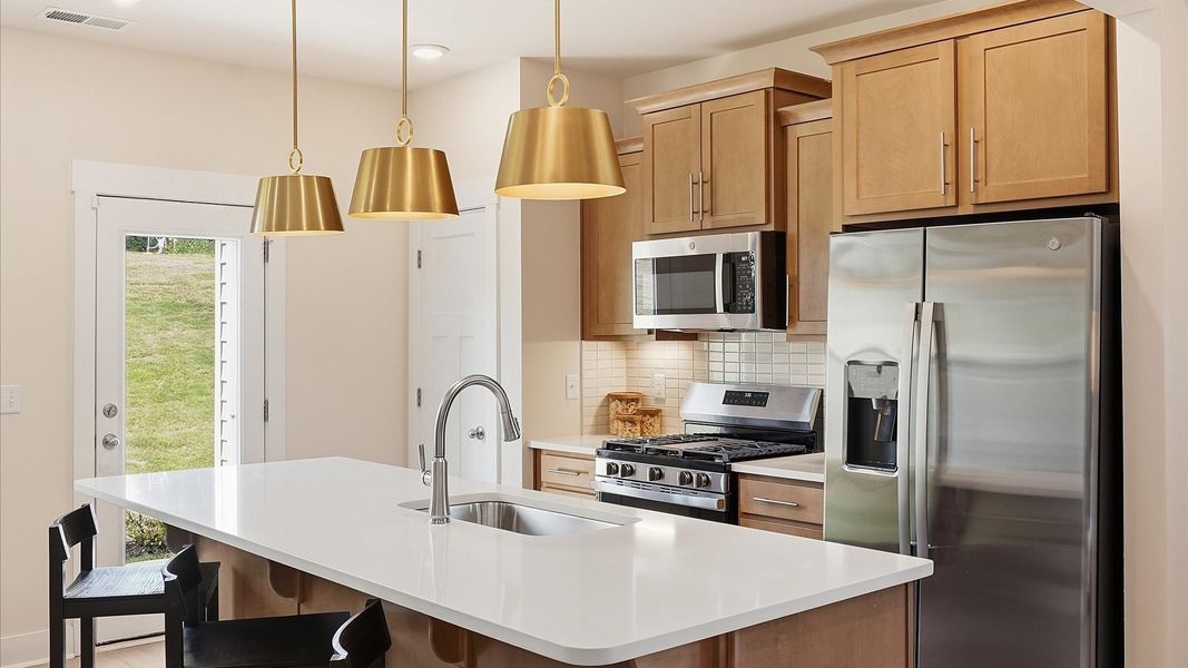Highly skilled design choices create a clean, open kitchen with a central island in this townhome at El Dorado Highly skilled design choices create a clean, open kitchen with a central island in this townhome at El Dorado