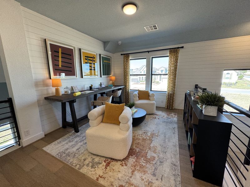 A chic sitting area with plush chairs, modern artwork, a sleek console table, and large windows offering ample natural light. A chic sitting area with plush chairs, modern artwork, a sleek console table, and large windows offering ample natural light.