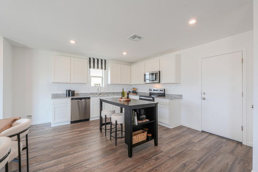 A kitchen with white cabinets. A kitchen with white cabinets.