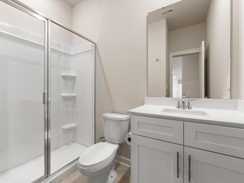 The secondary bathroom is perfect for guests and visitors.