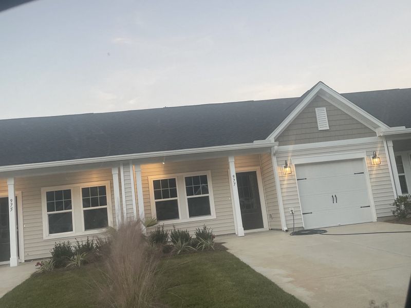 A charming single-story home with a tidy lawn in Hammock Walk at Nexton by Ashton Woods (Summerville, SC).