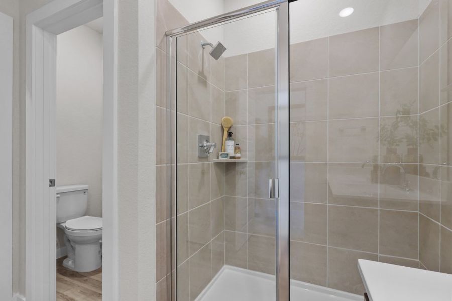 A shower with a glass door.