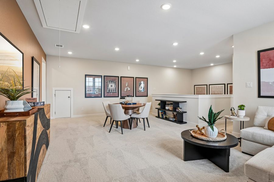 A large living room with a dining table and chairs.
