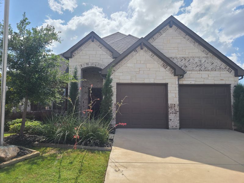 A charming brick and stone home with a manicured lawn in Summerwood by Altura Homes (Red Oak, TX). A charming brick and stone home with a manicured lawn in Summerwood by Altura Homes (Red Oak, TX).