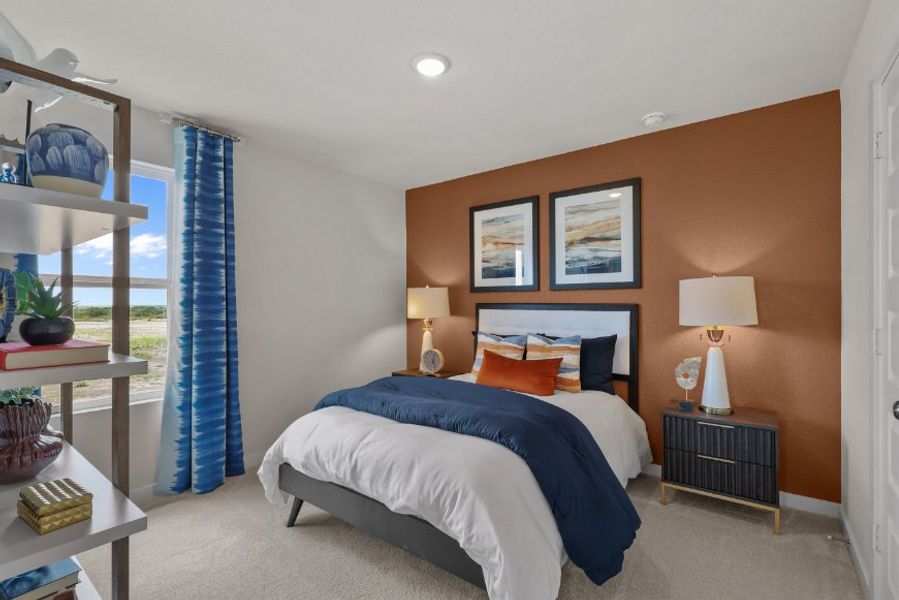 A bedroom with a bed and lamps.