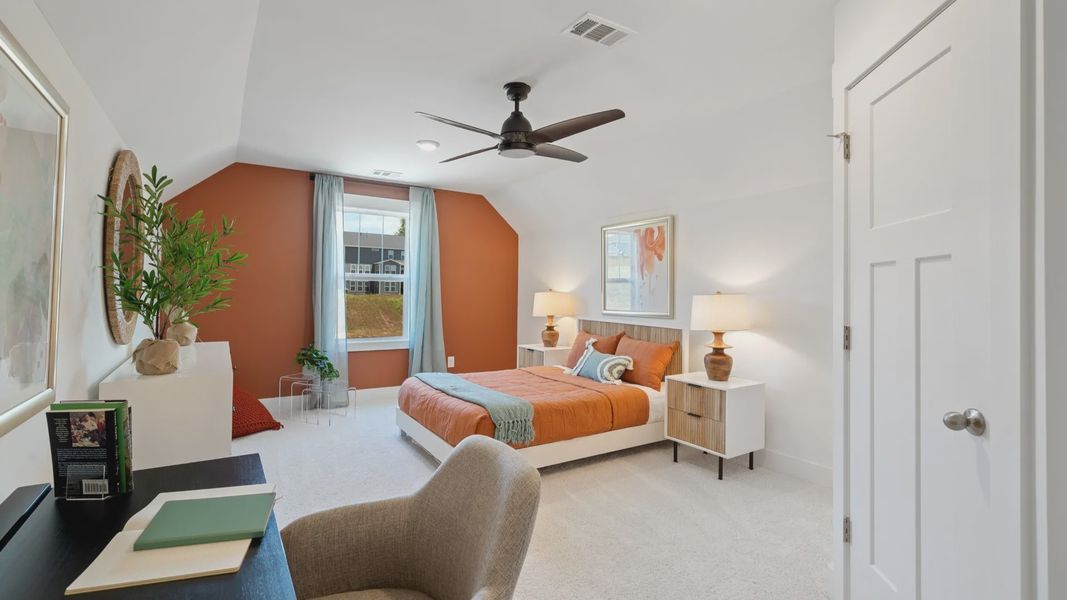 Elevated ceiling bonus room with plush carpet, ceiling fan, and large window at Magnolia Park by DRB Homes in Woodruff, SC Elevated ceiling bonus room with plush carpet, ceiling fan, and large window at Magnolia Park by DRB Homes in Woodruff, SC