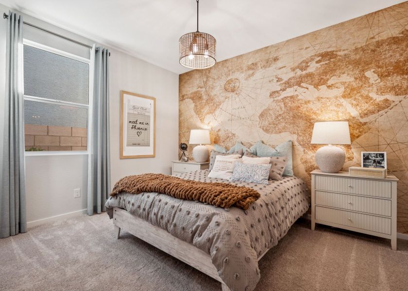 A bedroom with a bed and lamps.