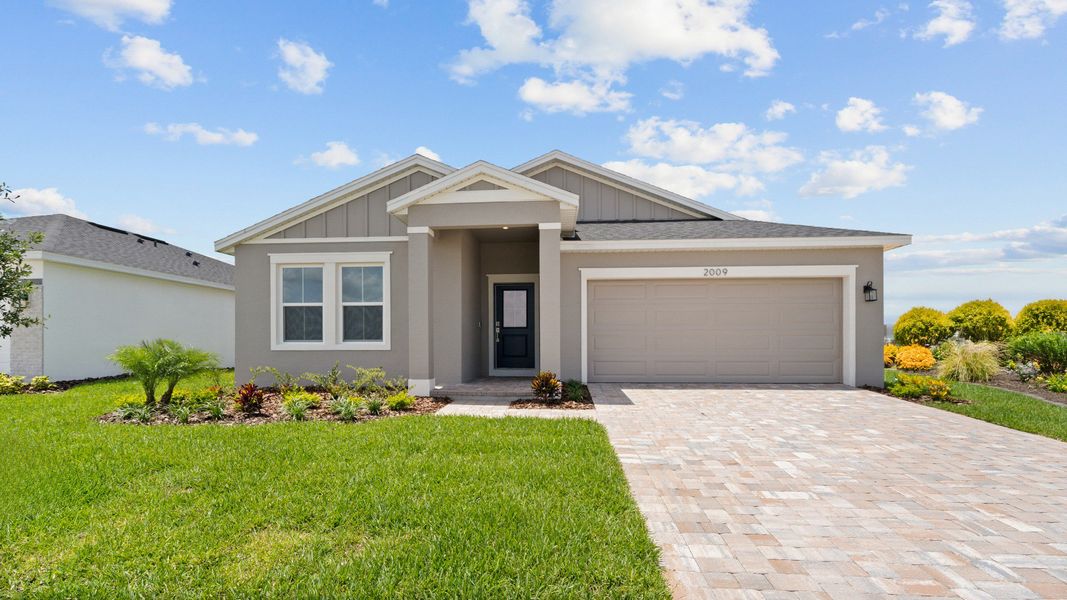 The Boca model – a beautiful new construction single-story home with a 2-car garage, covered entry, and brick paver driveway.