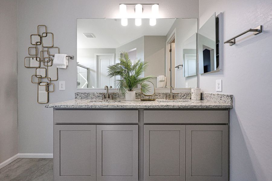 A bathroom with a large mirror. A bathroom with a large mirror.