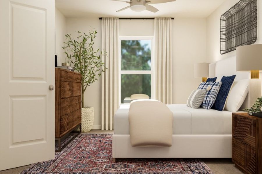 A living room with a white couch and a white chair.