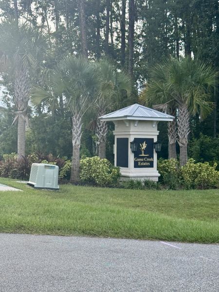 Entrance to Goose Creek Estates by Ashley Homes, LLC, featuring lush greenery and palm trees in Green Cove Springs, FL.