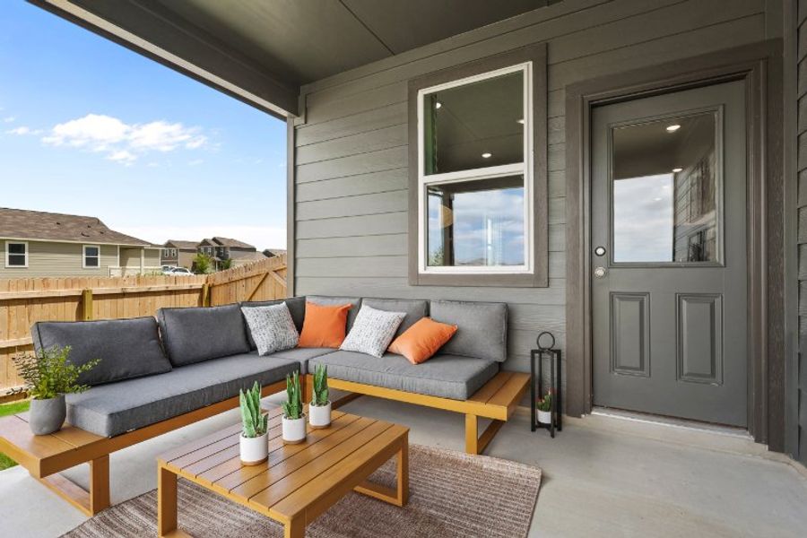 A couch and a table outside a house.