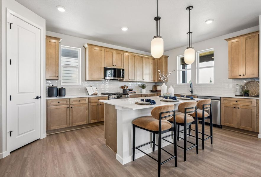 A kitchen with a table and chairs. A kitchen with a table and chairs.