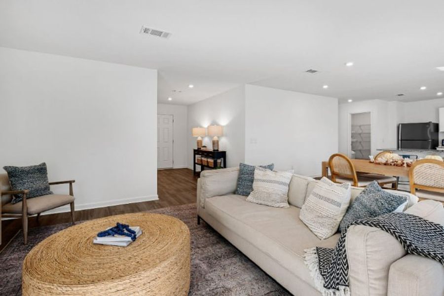 A living room with a couch and a table. A living room with a couch and a table.