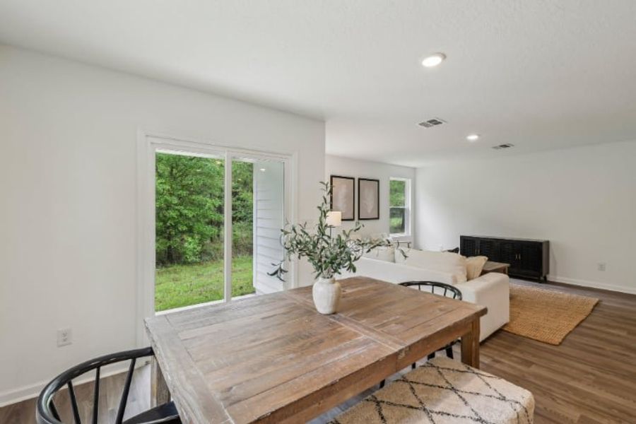 A living room with a table and couches. A living room with a table and couches.