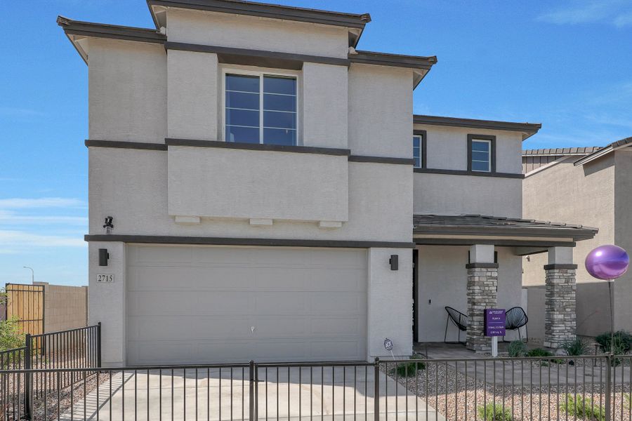 A white building with a black fence. A white building with a black fence.