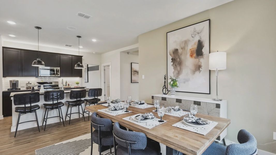 Luxurious open-plan design with sleek cabinetry, chic lighting, and exquisite furnishings at Simpson Crossing.