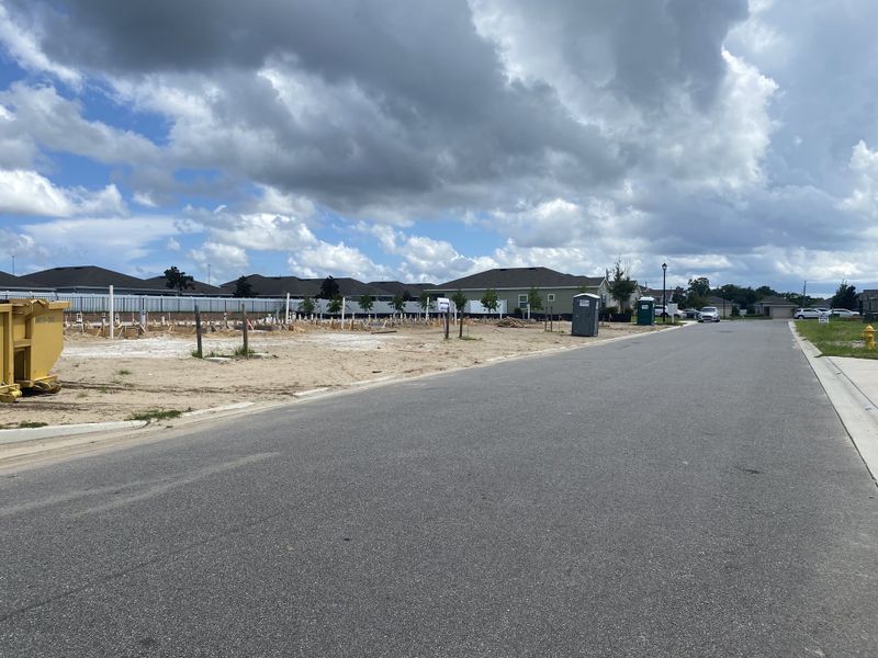 A developing street view in Mill Creek North Townhomes by Lennar, showcasing new construction in Jacksonville, FL.