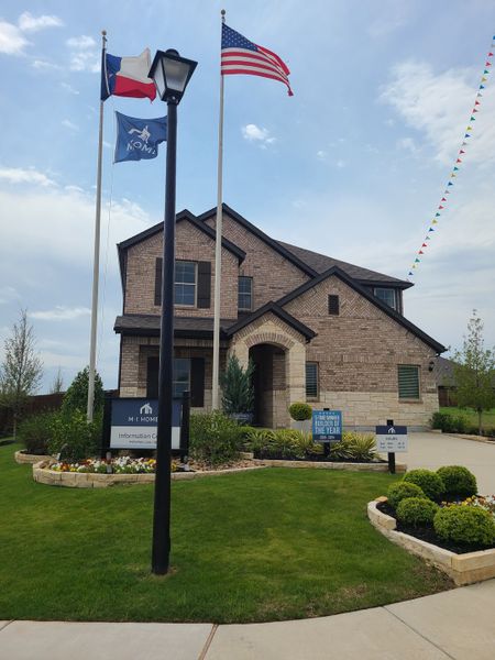 A charming brick home with manicured landscaping in Forest Park by M/I Homes (Princeton, TX).