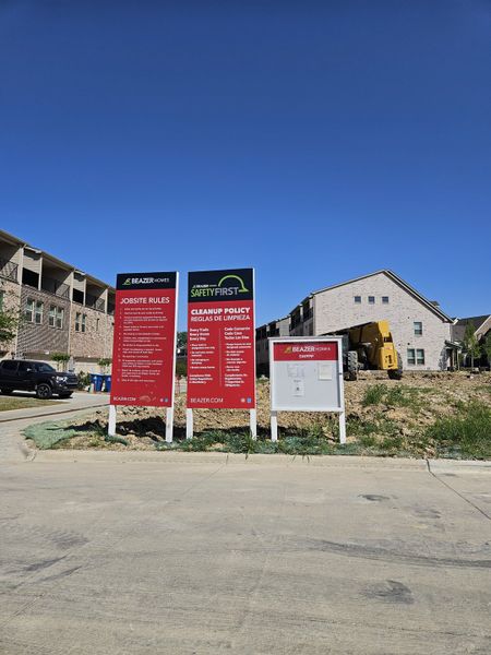 New construction site with safety signage in Bayside by Beazer Homes, Rowlett, TX, showcasing ongoing residential development.