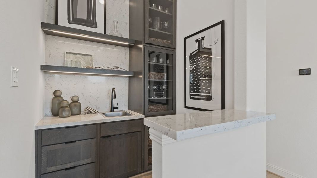 Sleek dark wood cabinetry and marble surfaces epitomize elegance in Oakwood Estates' stylish wet bar. Sleek dark wood cabinetry and marble surfaces epitomize elegance in Oakwood Estates' stylish wet bar.