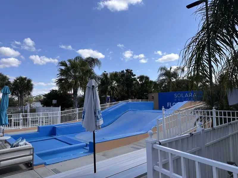 A fun-filled FlowRider surf simulator at Solara Resort, surrounded by tropical scenery in Solara Resort by Mattamy Homes (Kissimmee, FL).