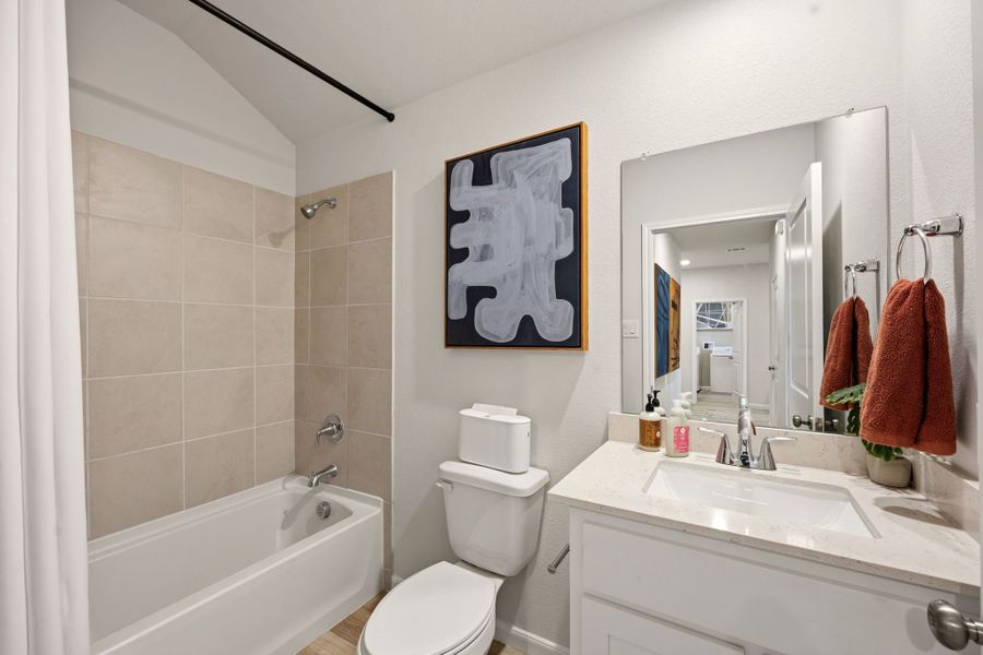 A bathroom with a sink toilet and a bathtub. A bathroom with a sink toilet and a bathtub.