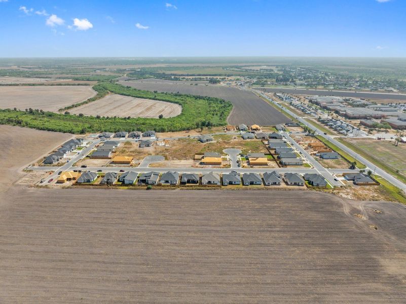 Aerial view of the The Heights at Riverbend II community in Brownsville, TX, showing layout and nearby surroundings (Image 9). Aerial view of the The Heights at Riverbend II community in Brownsville, TX, showing layout and nearby surroundings (Image 9).