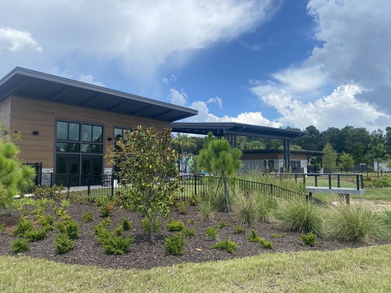 A modern community center with lush landscaping in RiverTown - Cove by Mattamy Homes (St. Johns, FL).