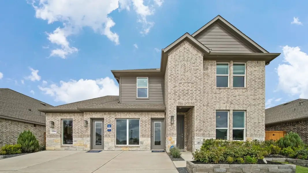 Front exterior of a home in the Sunterra community, located in Katy, TX (Image 5).