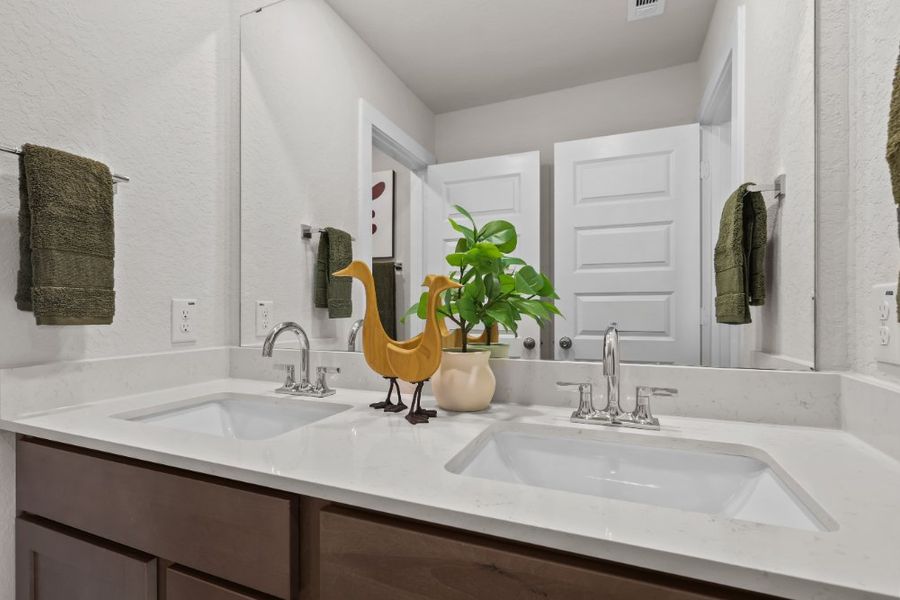 A bathroom with a sink and a mirror. A bathroom with a sink and a mirror.