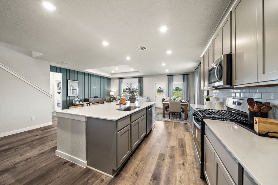 A kitchen with a wood floor.