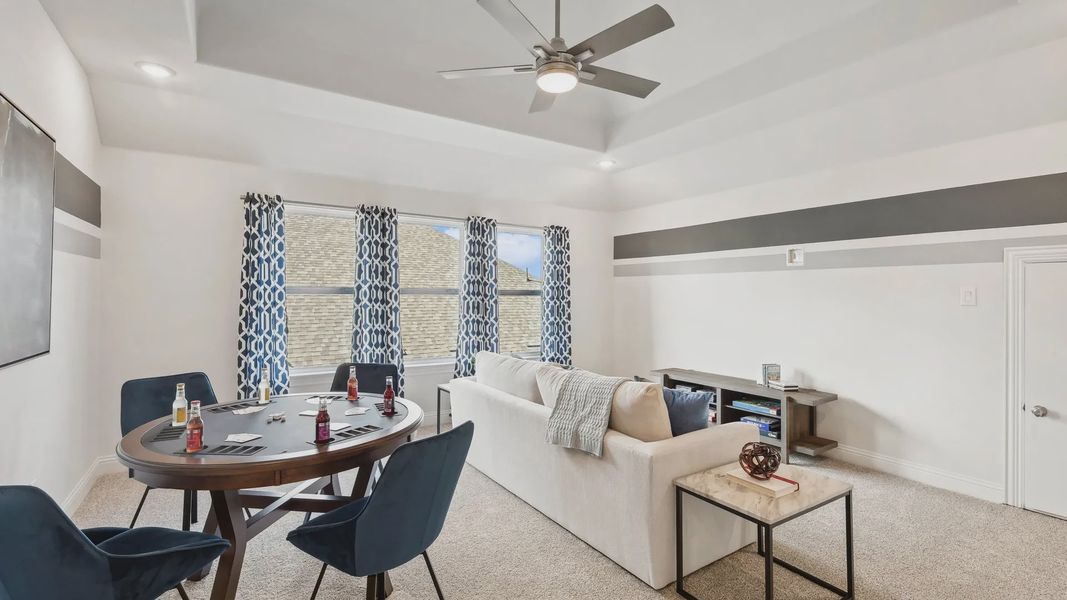 Ridge Crossing's sophisticated living room boasts a stylish ceiling fan and chic geometric curtains. Ridge Crossing's sophisticated living room boasts a stylish ceiling fan and chic geometric curtains.