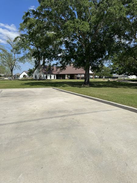 A spacious lot with mature trees in Windrow by Centex, Hockley, TX, offering ample greenery and serene surroundings.