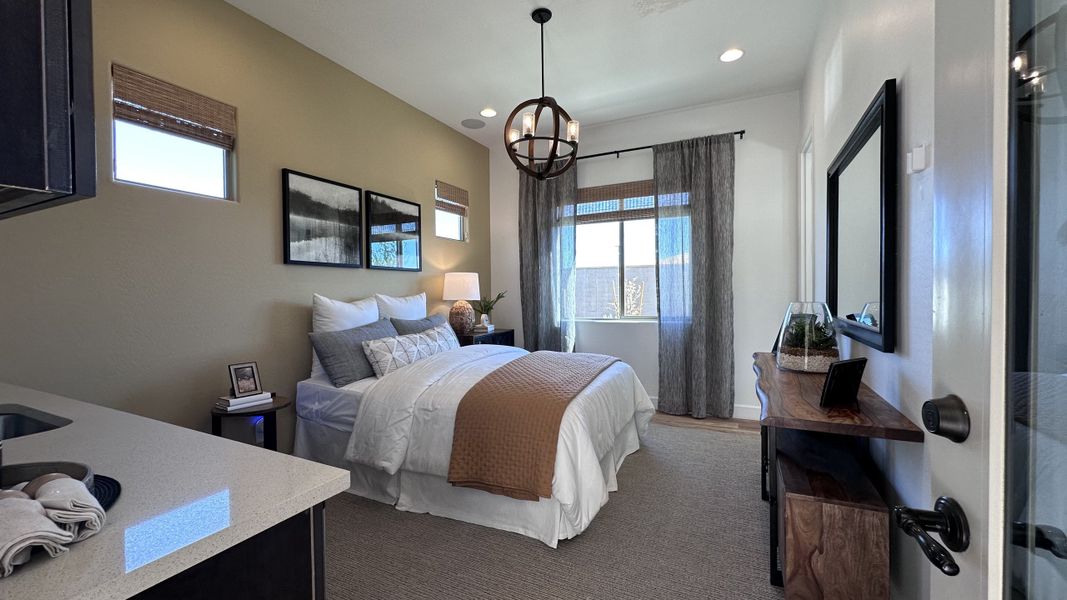 A cozy bedroom featuring a plush bed, wooden accents, soft lighting, and elegant curtains for a serene atmosphere.