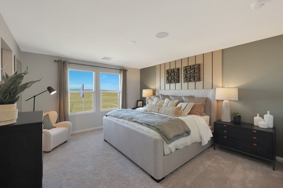 A bedroom with a bed and a chair. A bedroom with a bed and a chair.