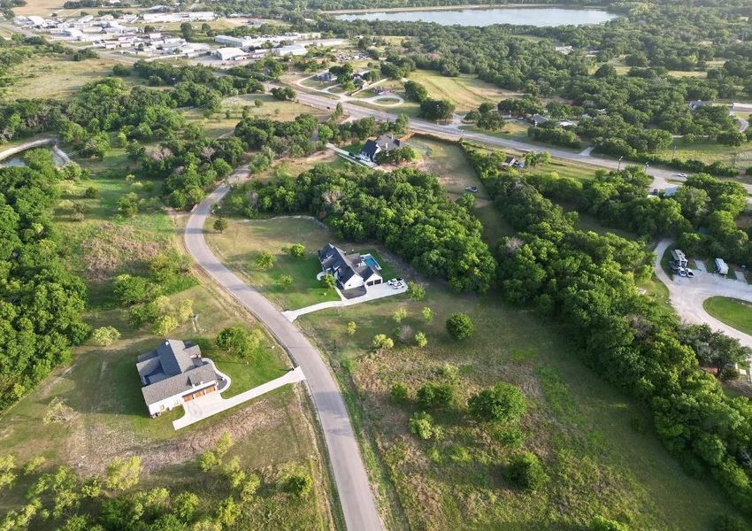 Aerial view of the Woodland Lakes community in Weatherford, TX, showing layout and nearby surroundings (Image 1). Aerial view of the Woodland Lakes community in Weatherford, TX, showing layout and nearby surroundings (Image 1).