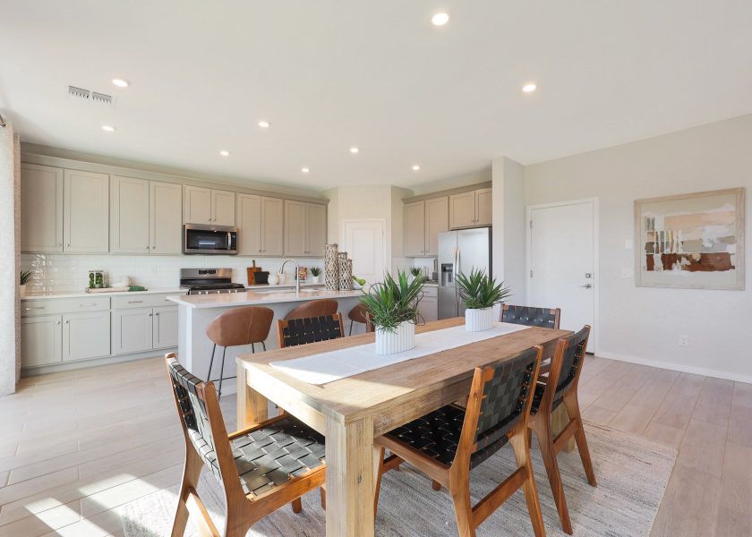 A kitchen with a dining table.