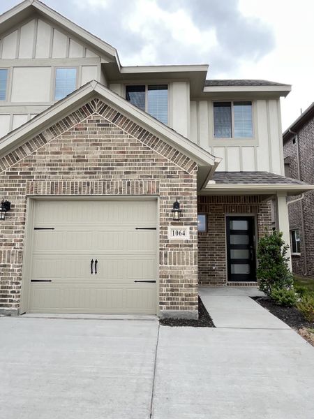 A charming brick and stucco home with modern accents in Elevon by Pacesetter Homes (Lavon, TX).