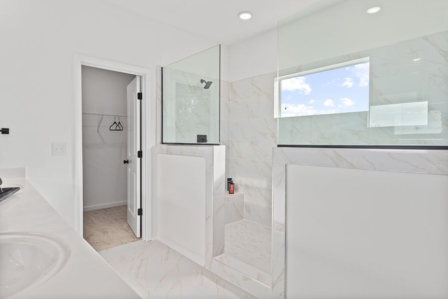 A bathroom with a glass shower. A bathroom with a glass shower.