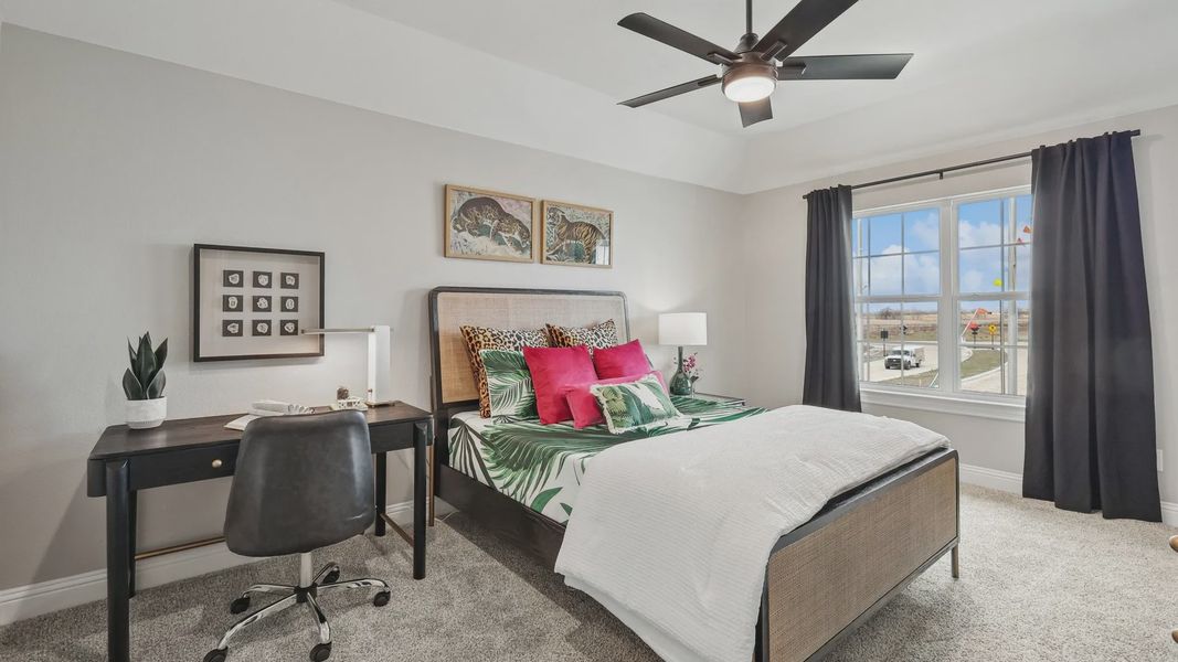 Spacious bedroom with luxe tropical bedding, sleek furnishings, and expansive window–Green Meadows. Spacious bedroom with luxe tropical bedding, sleek furnishings, and expansive window–Green Meadows.