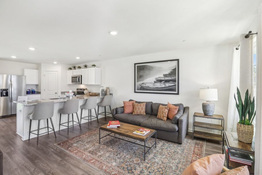 A living room with a couch and a table. A living room with a couch and a table.