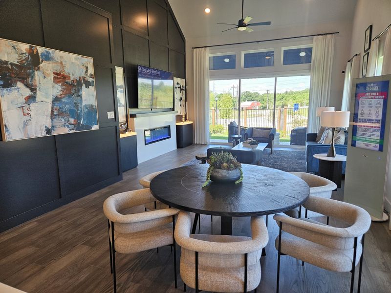 A modern living area with a sleek black accent wall, abstract art, elegant seating, and large windows for natural light. A modern living area with a sleek black accent wall, abstract art, elegant seating, and large windows for natural light.