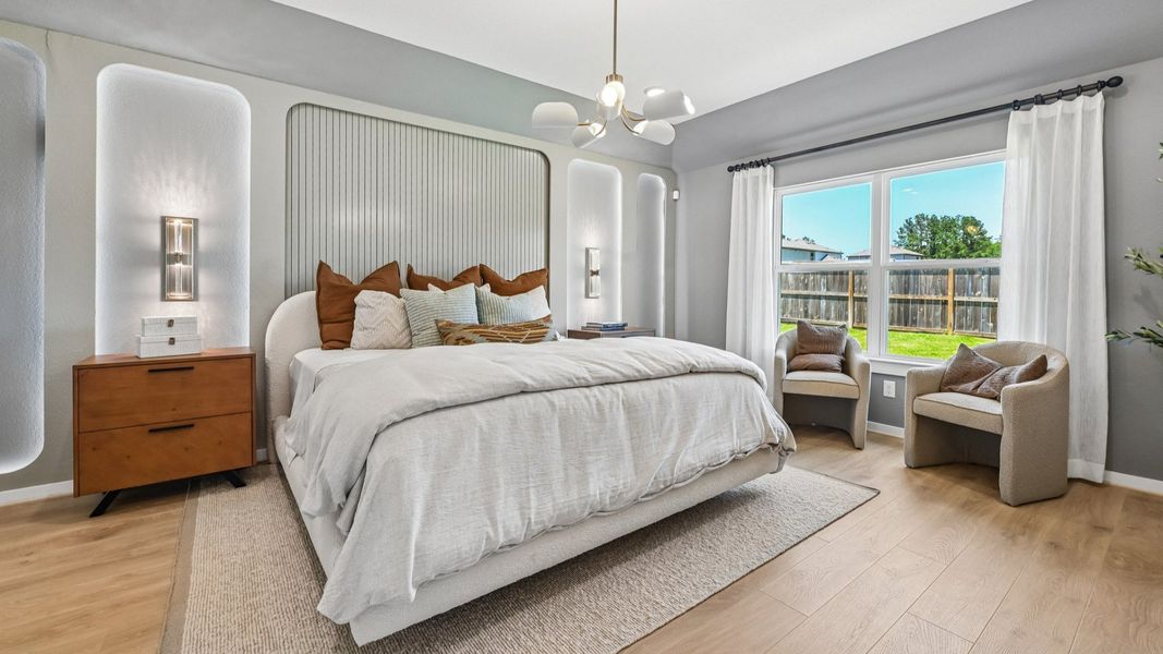 Stunning wall paneling and oversized windows enhance this luxury bedroom’s sophisticated ambiance in Cielo.