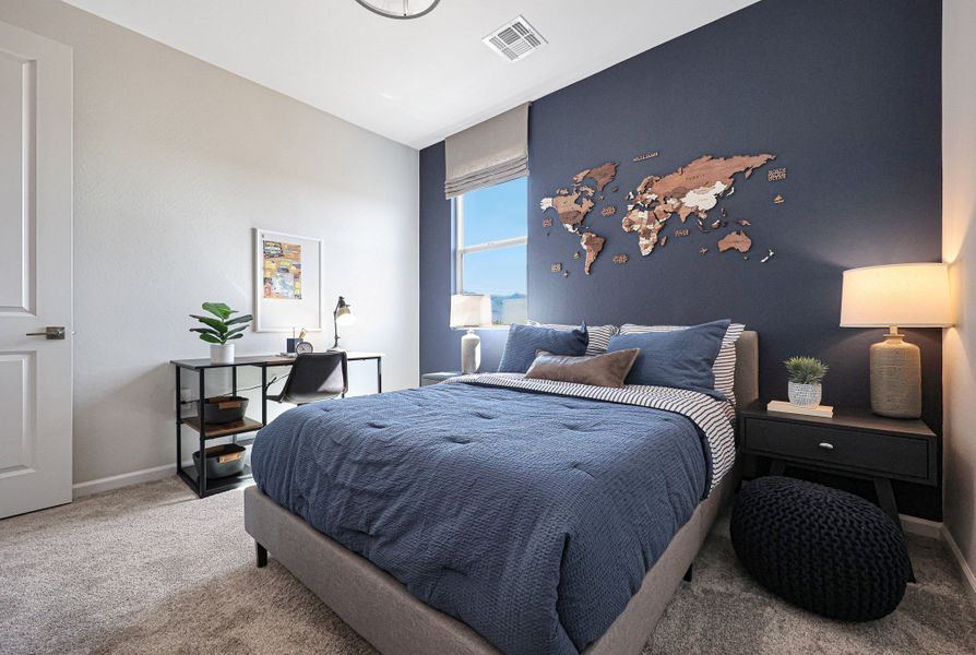 A bedroom with a bed and a desk. A bedroom with a bed and a desk.