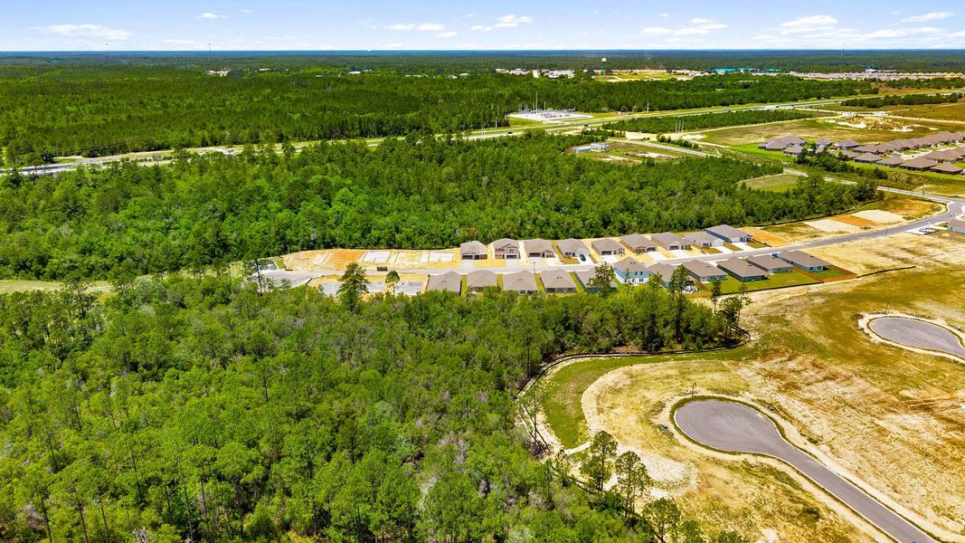 Aerial view of the Magnolia at the Bluffs Phase 3 community in Freeport, FL, showing layout and nearby surroundings (Image 10). Aerial view of the Magnolia at the Bluffs Phase 3 community in Freeport, FL, showing layout and nearby surroundings (Image 10).